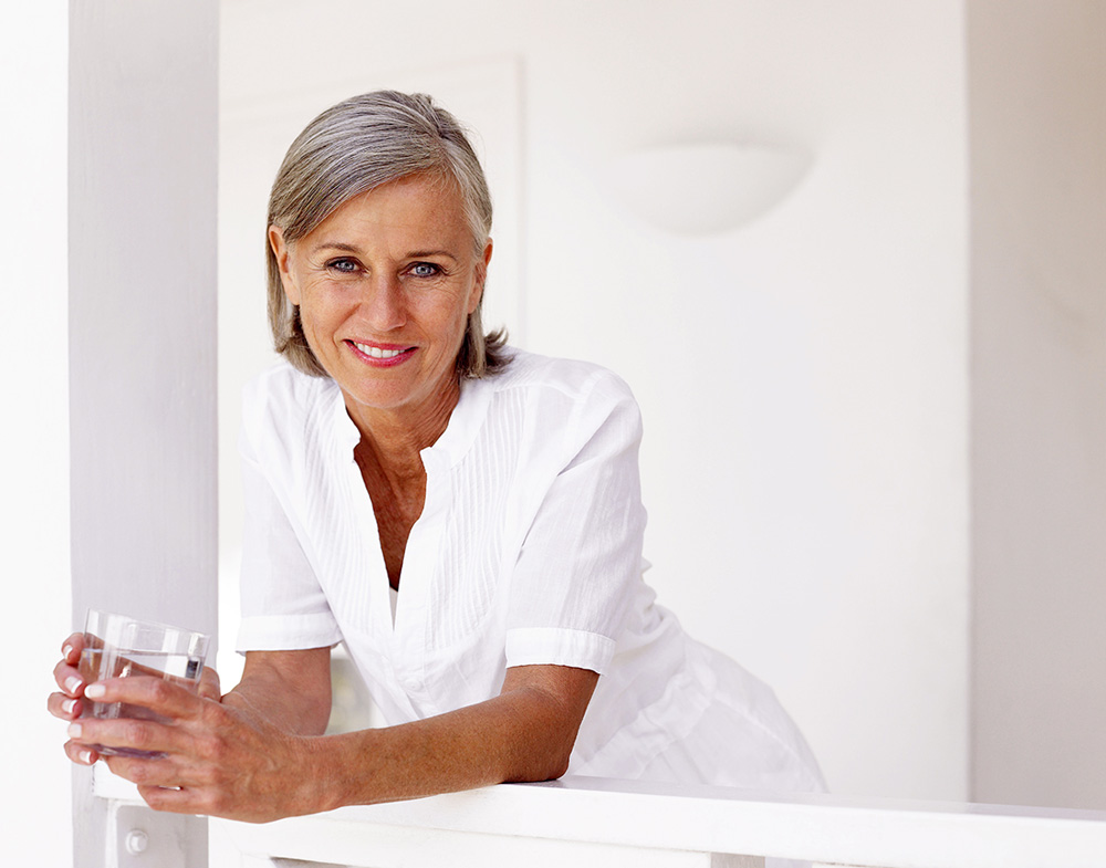 smiling postmenopausal woman with grey hair